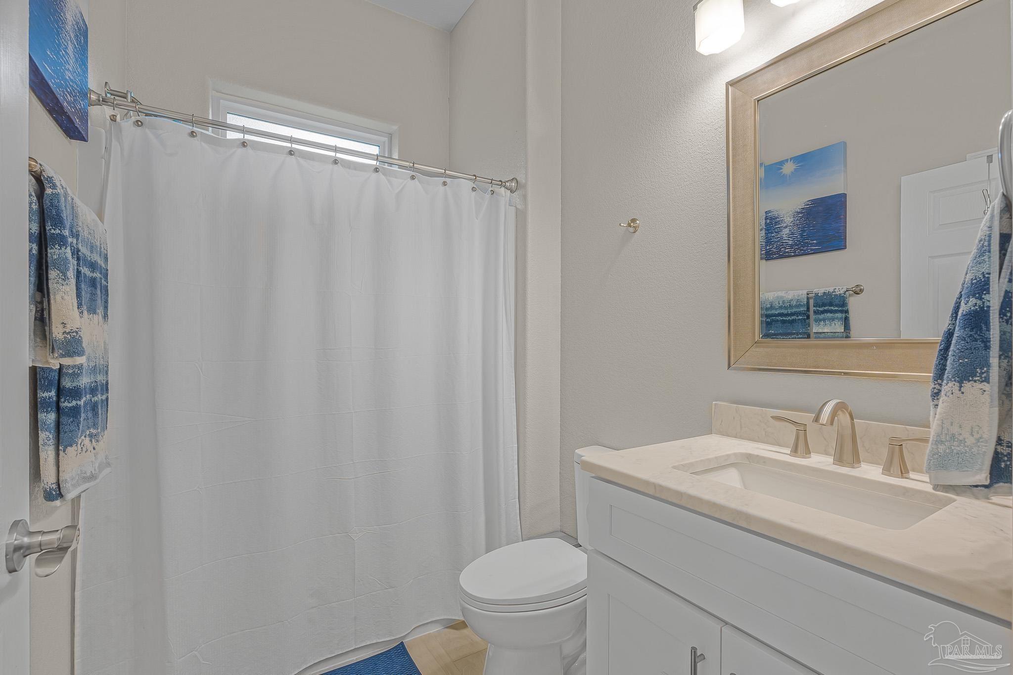 6245 Muldoon Road Pensacola, FL 32526 - Photo 19 of 44 a bathroom with a granite countertop sink toilet and a mirror