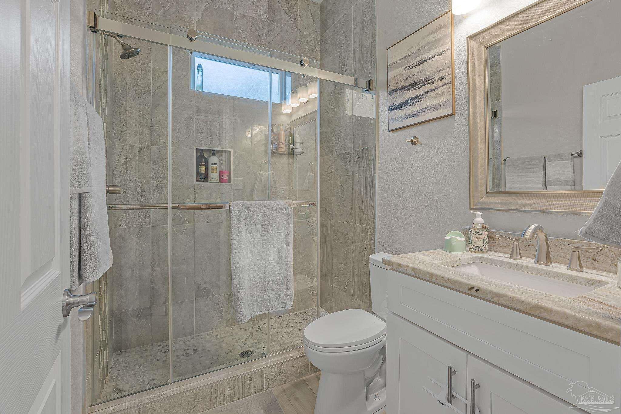 6245 Muldoon Road Pensacola, FL 32526 - Photo 22 of 44 a bathroom with a shower toilet and sink