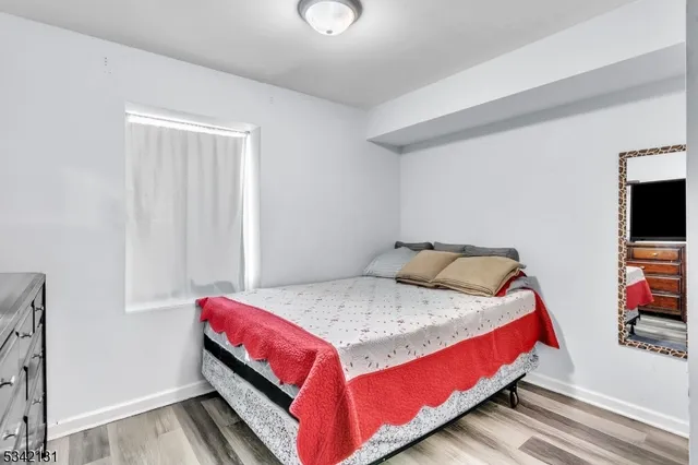 a bed sitting in a bedroom next to a window