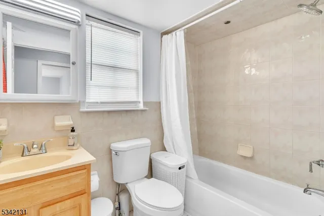 a bathroom with a toilet a sink and bathtub