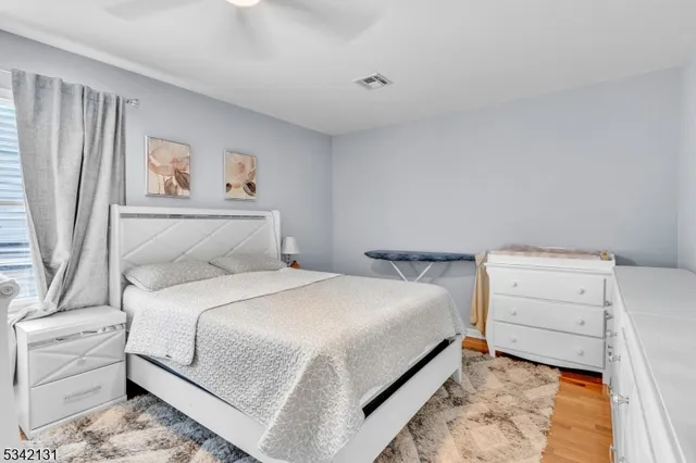 a bedroom with a bed and a painting on the wall