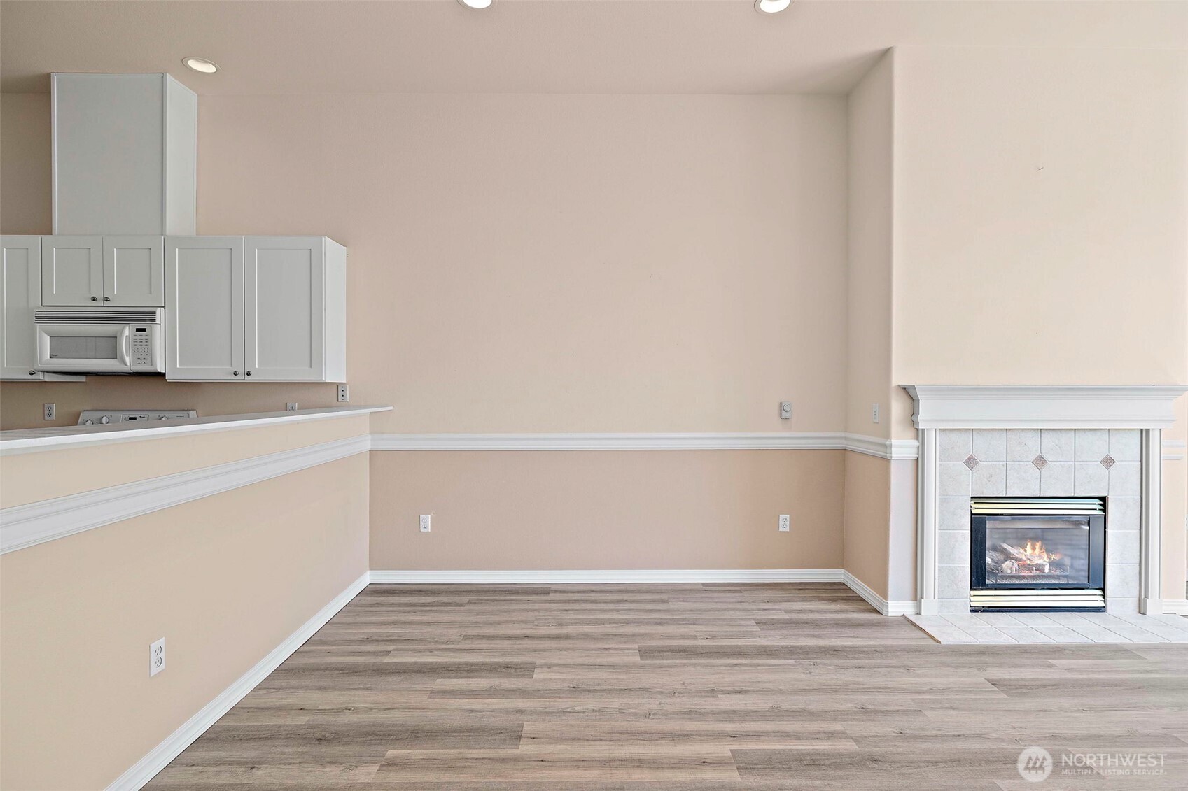 6831 Northeast 170th Street, Unit 306 Kenmore, WA 98028 - Photo 12 of 32 a view of an empty room with kitchen and a window
