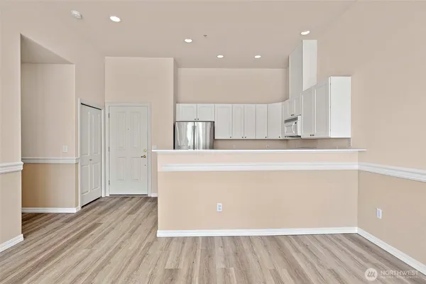 a view of a kitchen with wooden floor