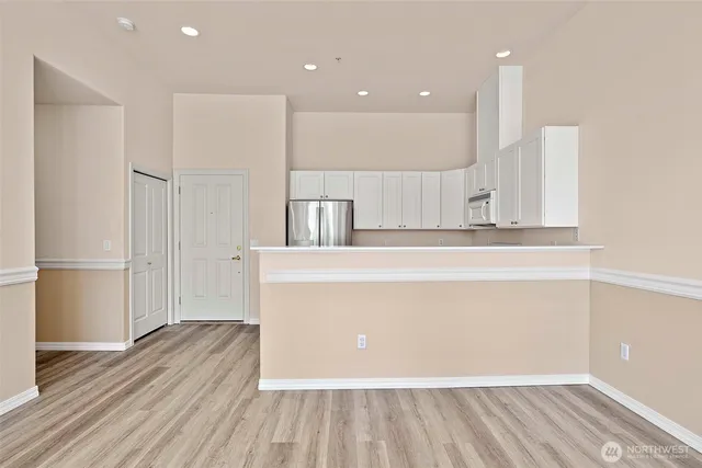 a view of a kitchen with wooden floor