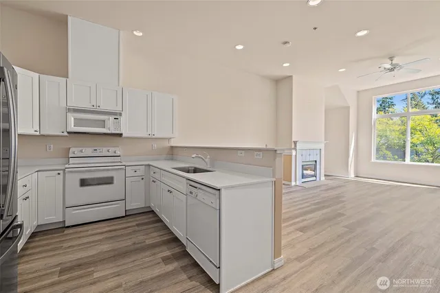 a kitchen with a stove a sink and a microwave