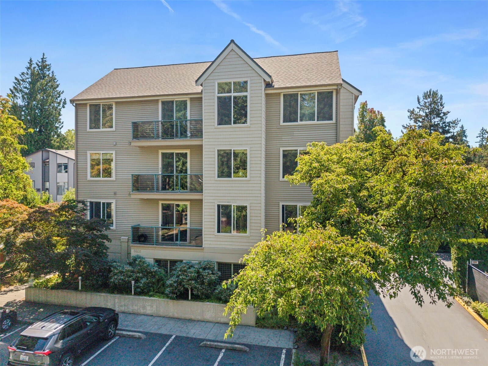 6831 Northeast 170th Street, Unit 306 Kenmore, WA 98028 - Photo 2 of 32 a front view of a house with a yard