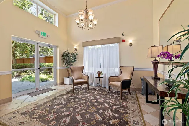 a living room with patio furniture and a chandelier