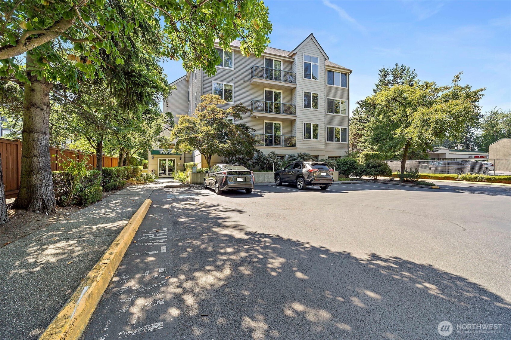 6831 Northeast 170th Street, Unit 306 Kenmore, WA 98028 - Photo 30 of 32 a building with trees in front of it