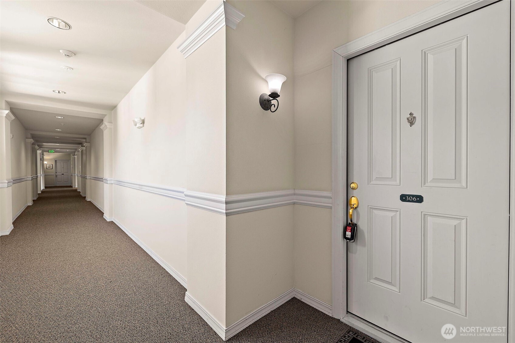 6831 Northeast 170th Street, Unit 306 Kenmore, WA 98028 - Photo 3 of 32 a view of a hallway with white walls