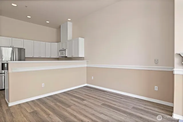 a view of a kitchen with a refrigerator and a sink