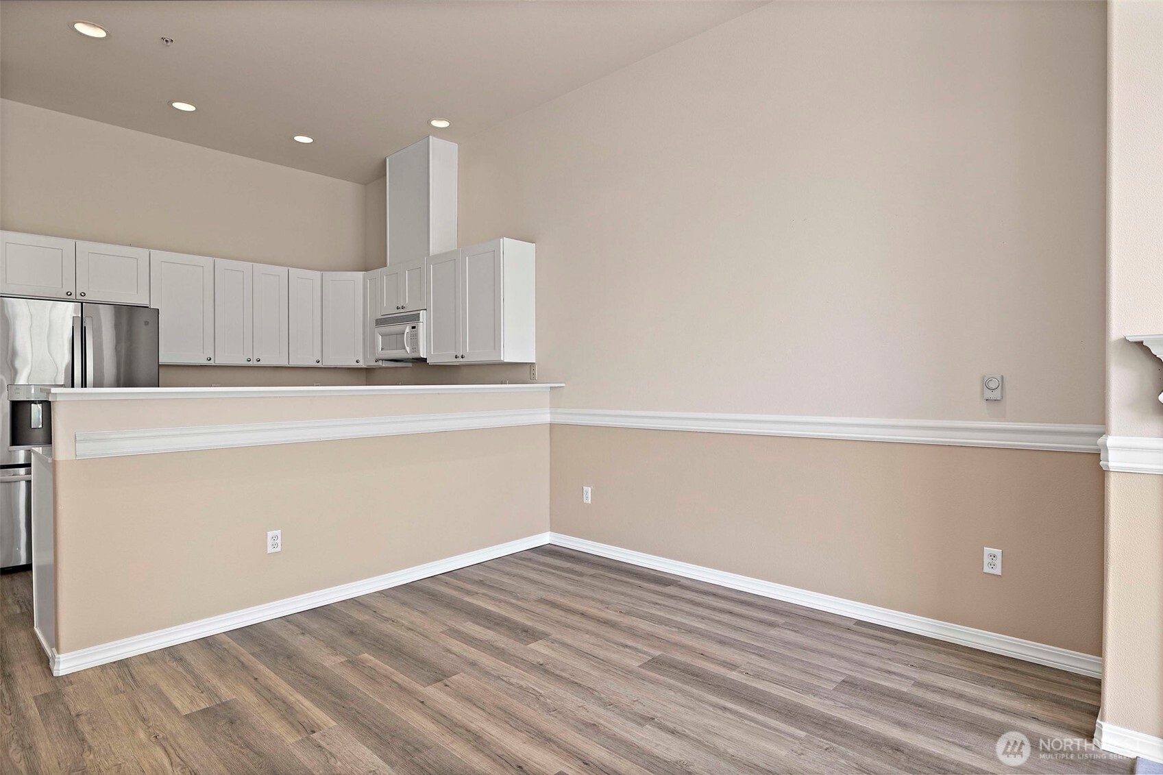 6831 Northeast 170th Street, Unit 306 Kenmore, WA 98028 - Photo 4 of 32 a view of a kitchen with a refrigerator and a sink