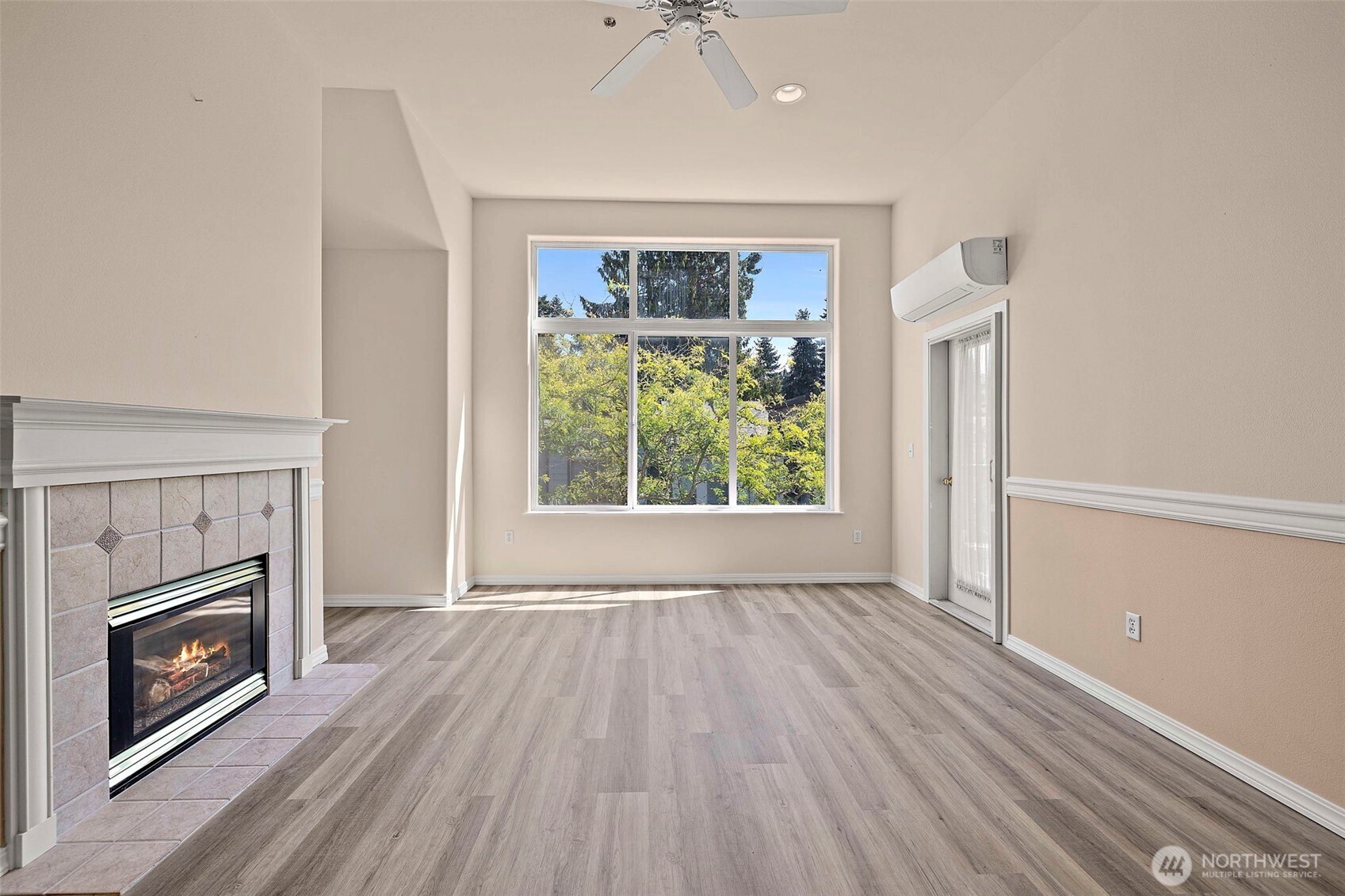 6831 Northeast 170th Street, Unit 306 Kenmore, WA 98028 - Photo 10 of 32 a view of an empty room with a fireplace and a window