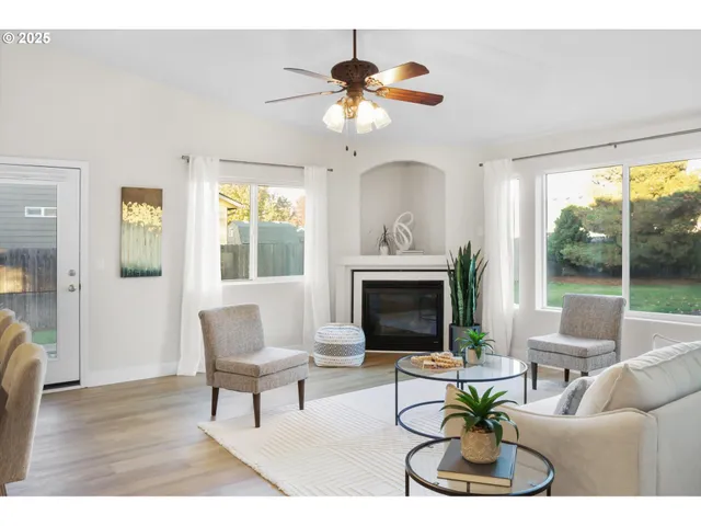 a living room with furniture a fireplace and a chandelier