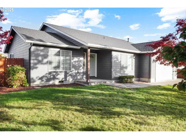 a view of a house with a swimming pool and a yard