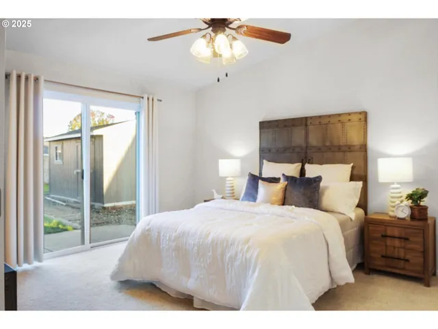 a large bed sitting in a bedroom next to a window