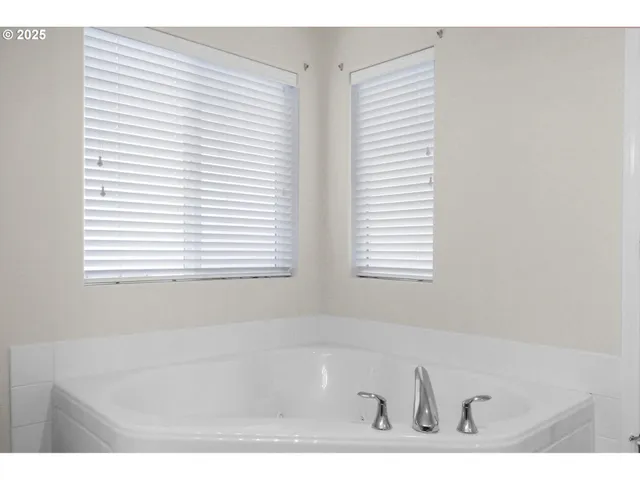 a bathroom with a bathtub and a window