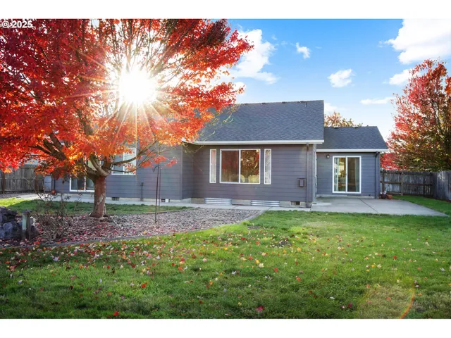 a backyard of a house with table and chairs