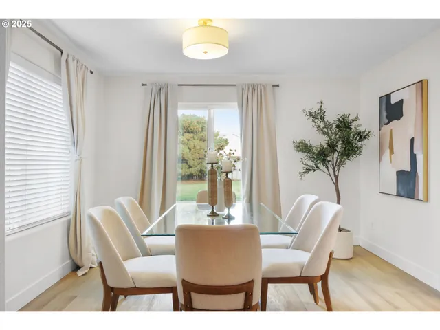 a view of a dining room with furniture and a potted plant