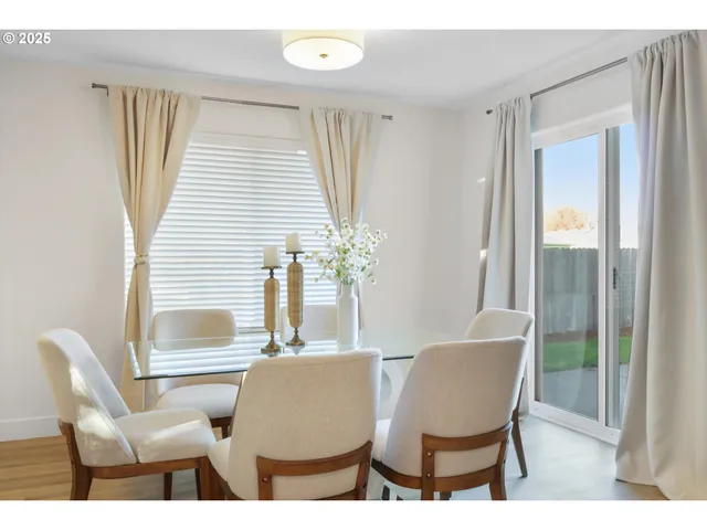 a dining room with furniture and wooden floor