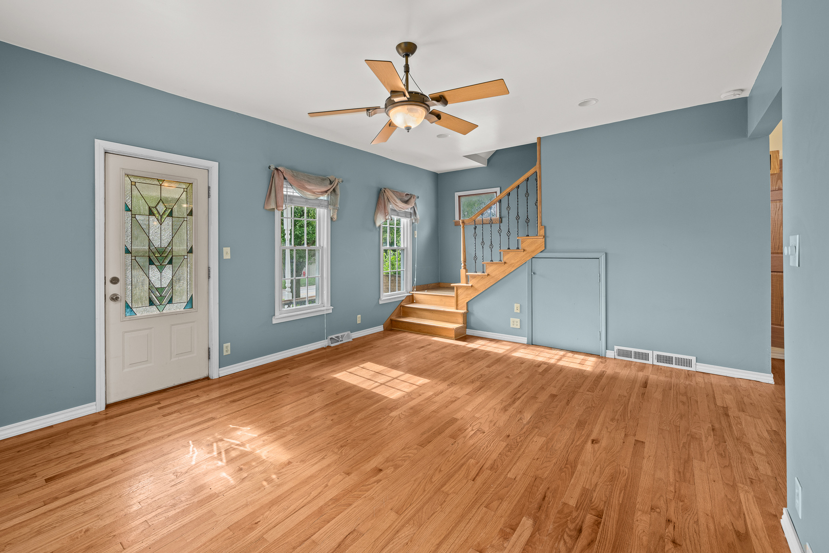 802 North High Street Port Byron, IL 61275 - Photo 13 of 43 a view of a livingroom with wooden floor and a ceiling fan
