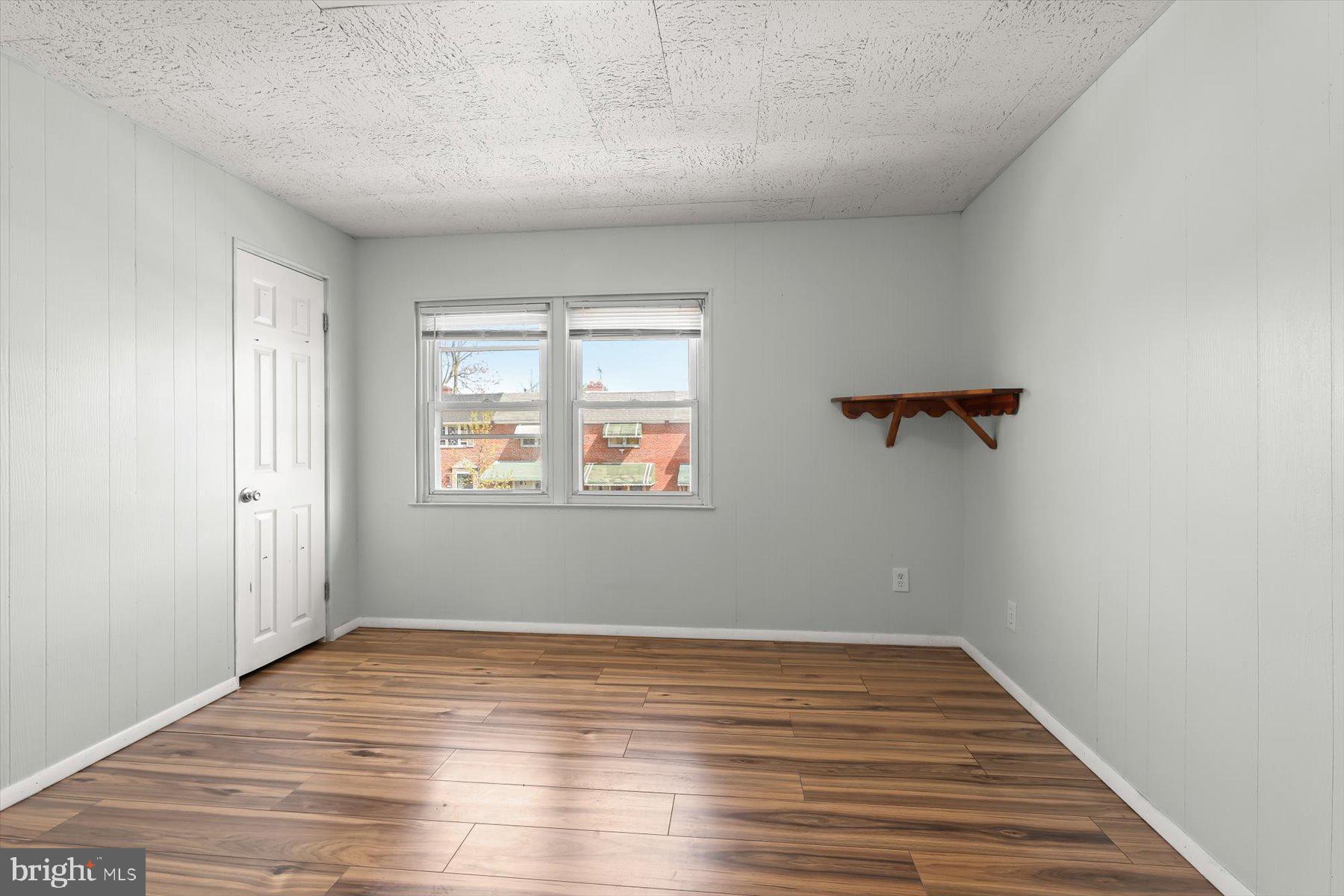 3720 St Victor Street Baltimore, MD 21225 - Photo 21 of 41 wooden floor in an empty room with a window