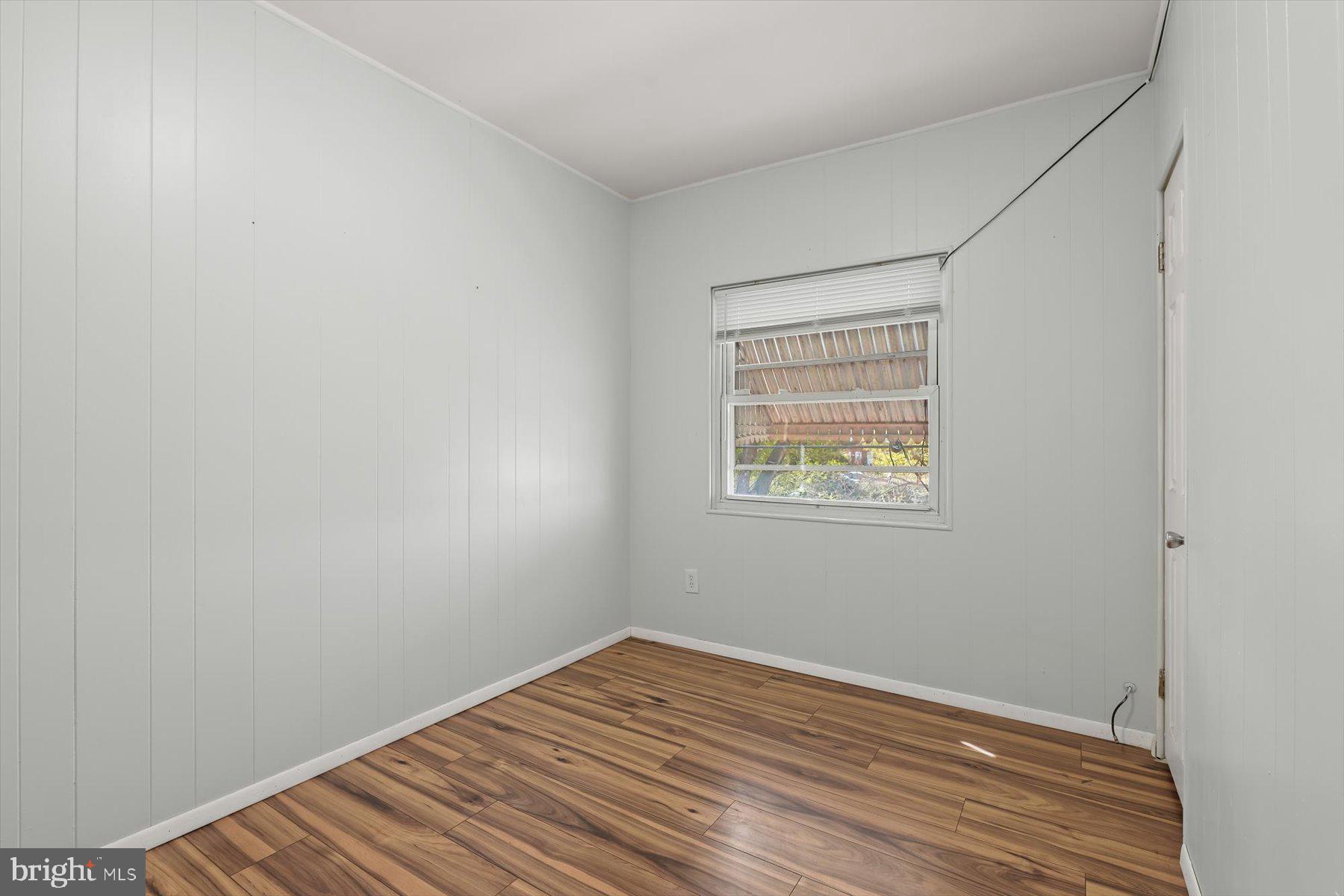 3720 St Victor Street Baltimore, MD 21225 - Photo 23 of 41 a view of an empty room with wooden floor and a window