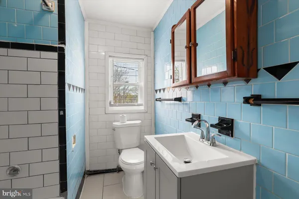 a bathroom with a sink toilet and mirror