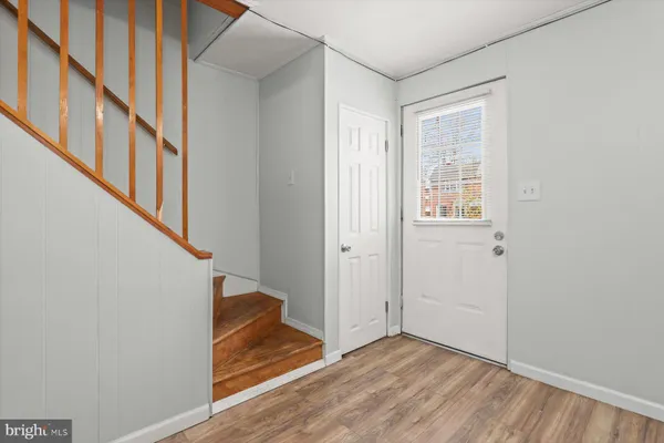a view of entryway with wooden floor and stairs