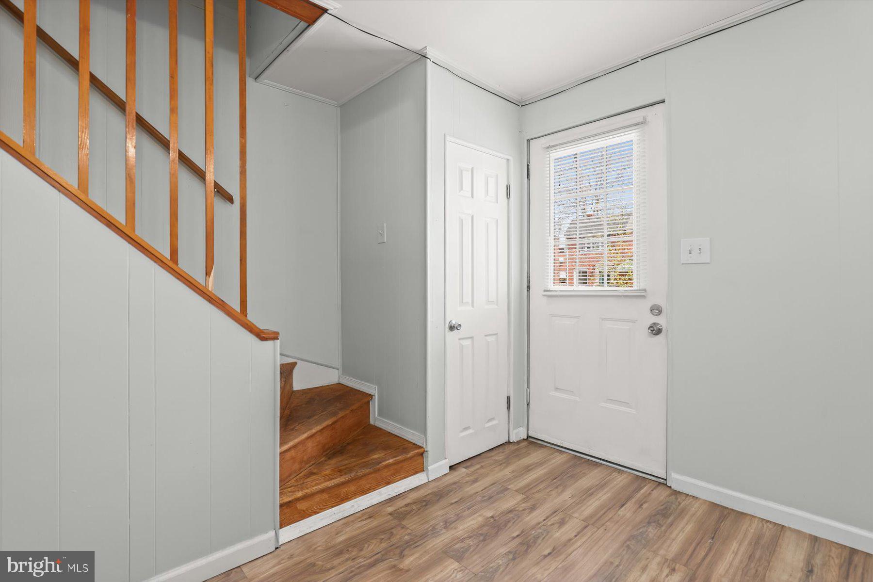 3720 St Victor Street Baltimore, MD 21225 - Photo 3 of 41 a view of entryway with wooden floor and stairs