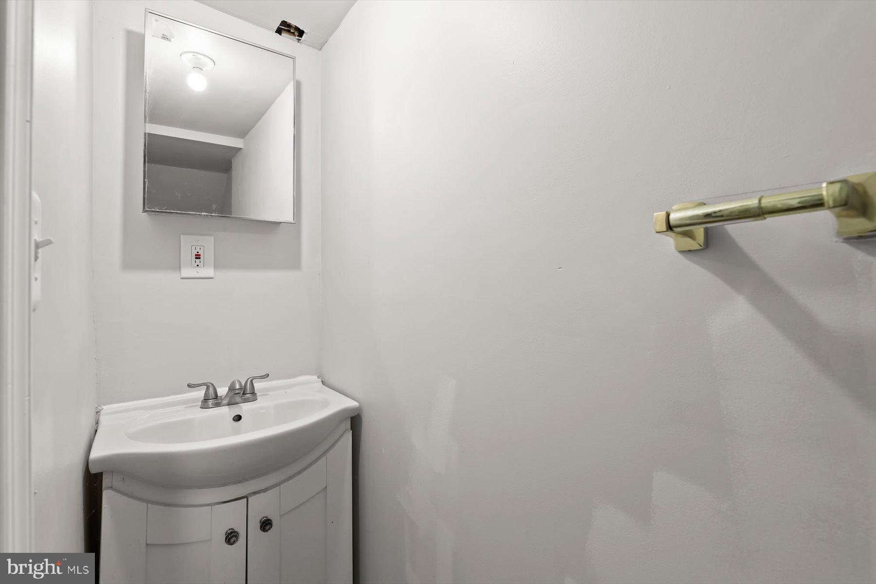 3720 St Victor Street Baltimore, MD 21225 - Photo 31 of 41 a bathroom with a sink and a mirror