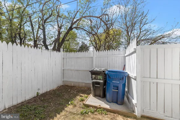 a view of balcony with wooden fence and trees