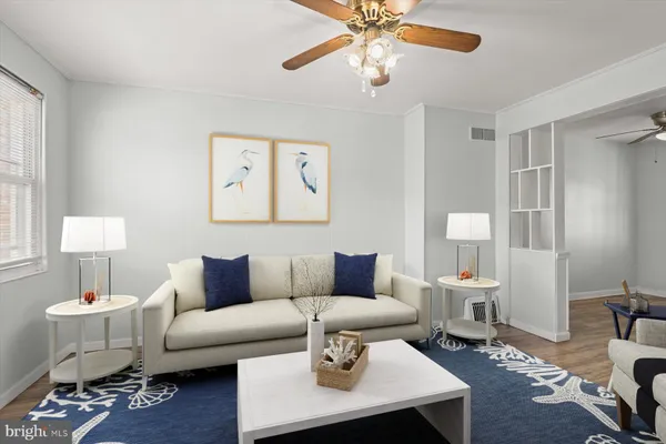 a living room with furniture and a lamp