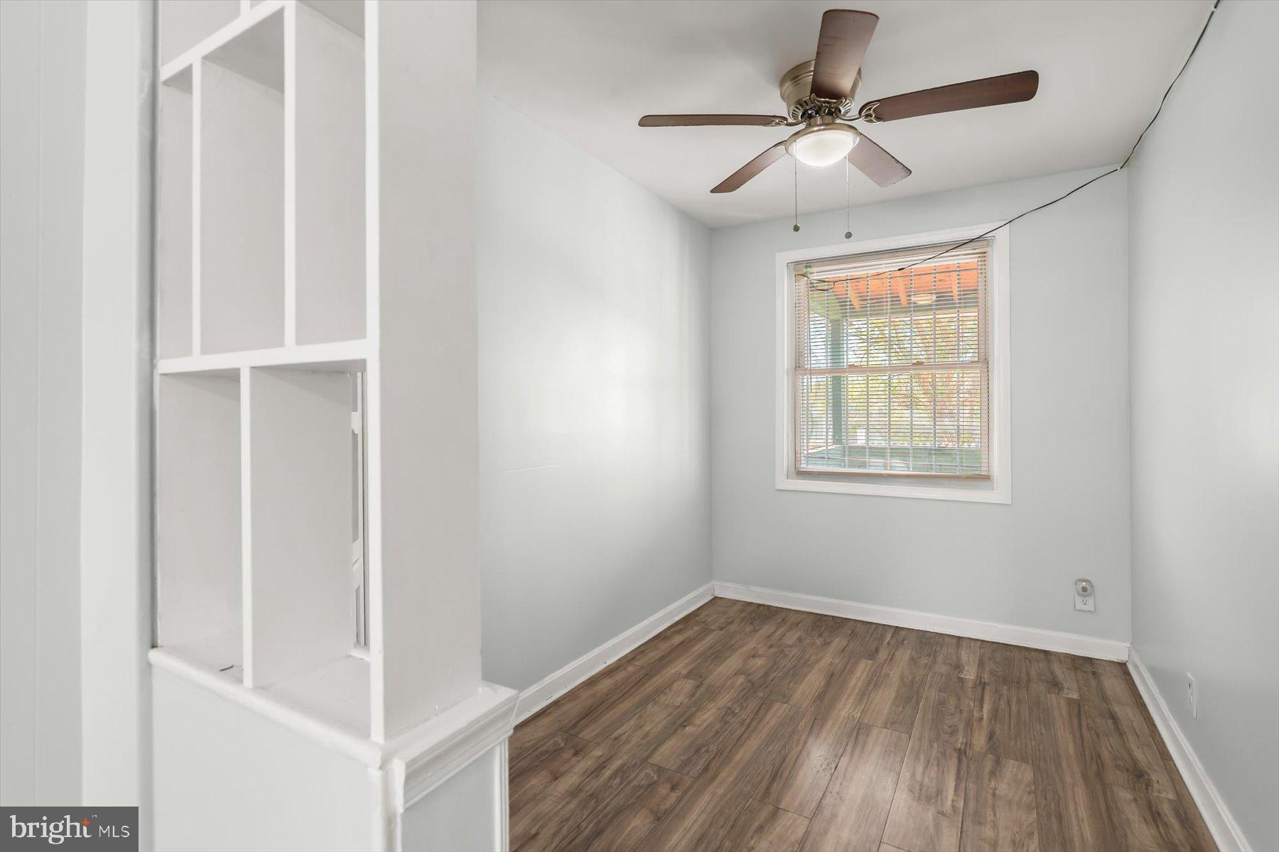 3720 St Victor Street Baltimore, MD 21225 - Photo 8 of 41 an empty room with a window and a ceiling fan
