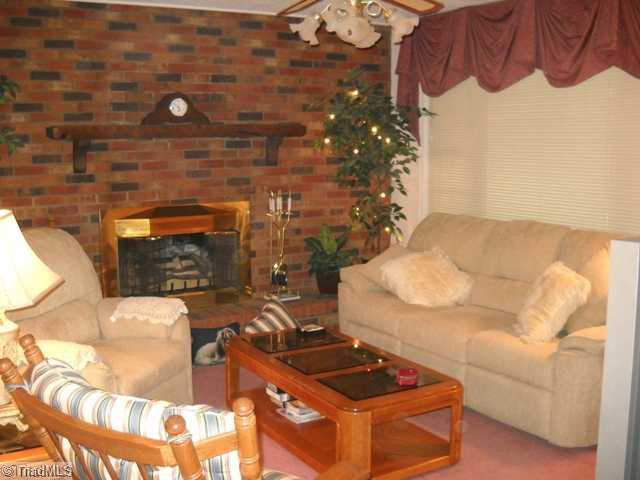 7105 Kingston Road Trinity, NC 27360 - Photo 3 of 16 Living Room. Beautiful brick fireplace with gas logs.