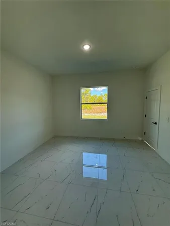 a view of a livingroom with a kitchen space