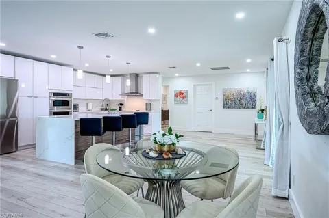 a kitchen with a sink a stove a refrigerator and cabinets