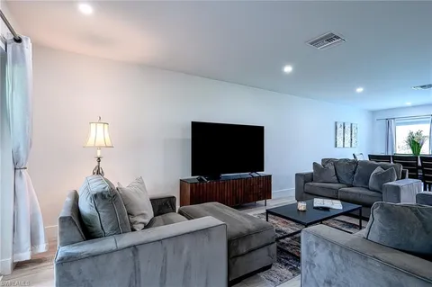 a bedroom with a bed a couch and a window