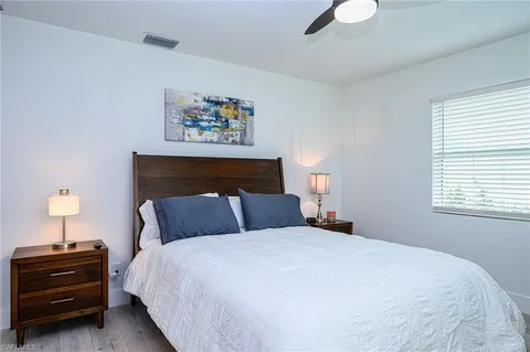 a bed sitting in a bedroom next to a window