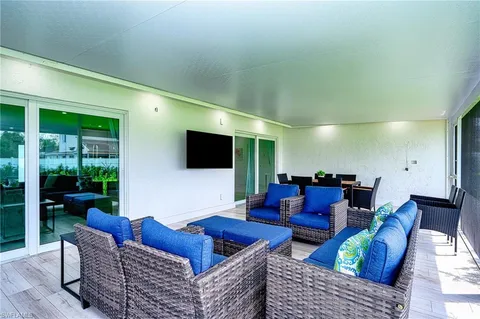 a patio with a table and chairs under an umbrella