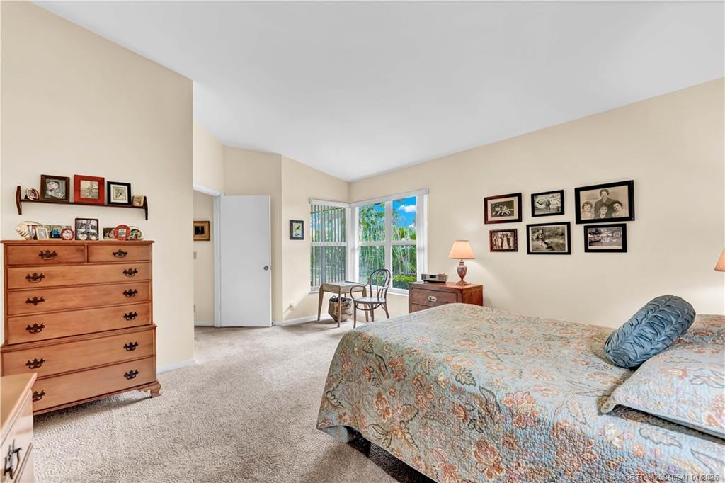 2437 Southwest Foxpoint Trail Palm City, FL 34990 - Photo 18 of 32 a bedroom with a bed and a dresser