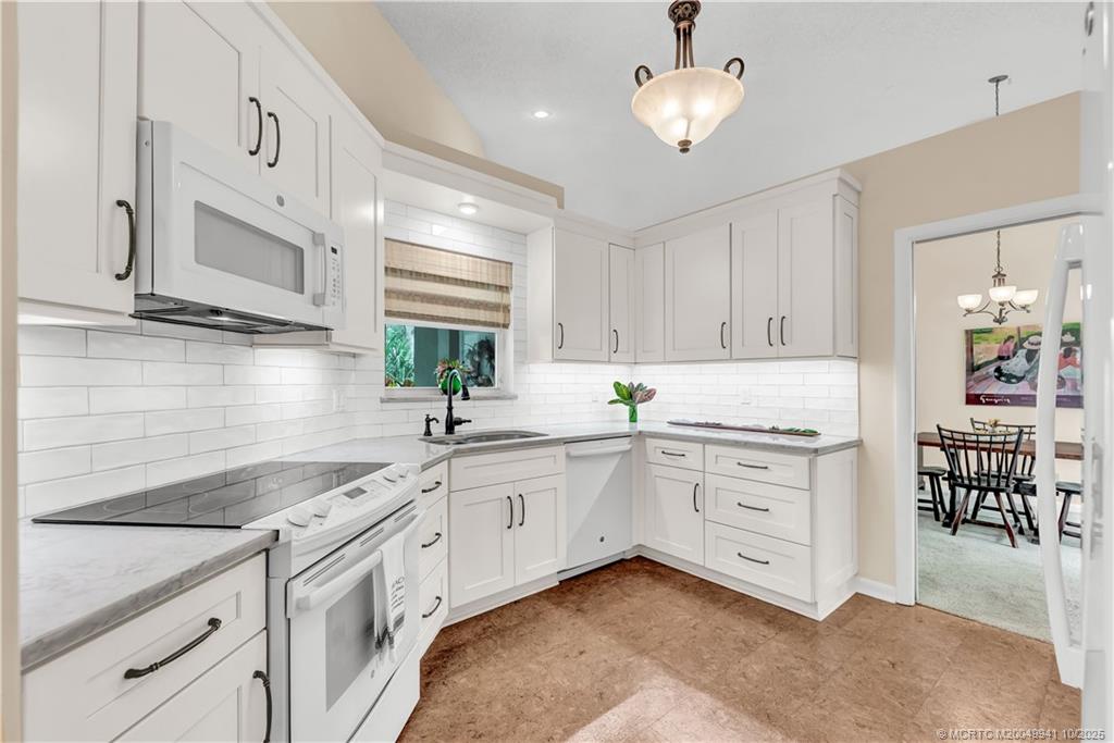 2437 Southwest Foxpoint Trail Palm City, FL 34990 - Photo 2 of 32 a kitchen with a sink cabinets and window