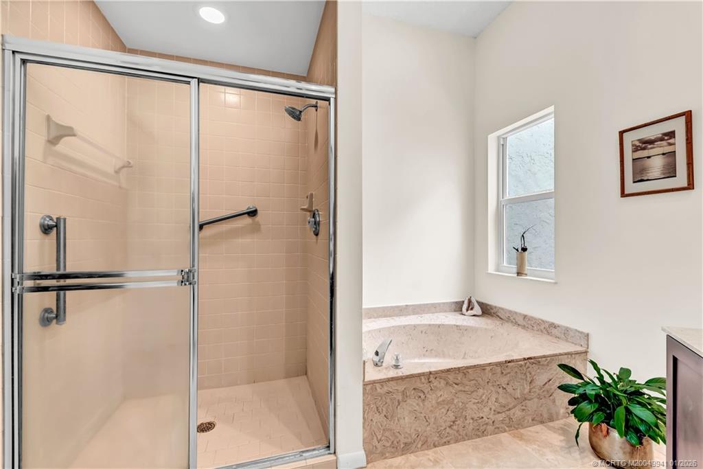 2437 Southwest Foxpoint Trail Palm City, FL 34990 - Photo 21 of 32 a bathroom with a shower and a bathtub
