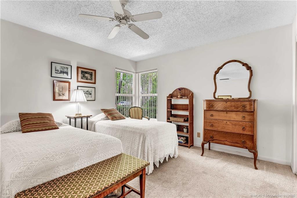2437 Southwest Foxpoint Trail Palm City, FL 34990 - Photo 22 of 32 a bedroom with a bed and a dresser
