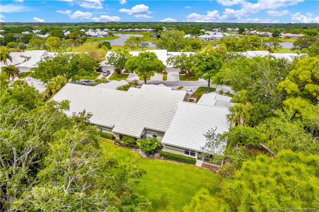 2437 Southwest Foxpoint Trail Palm City, FL 34990 - Photo 27 of 32 an aerial view of residential houses with outdoor space and swimming pool
