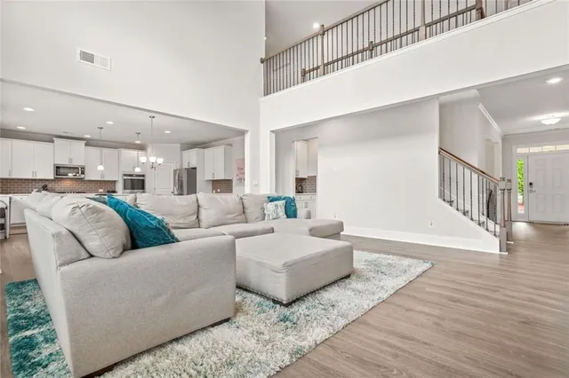 a living room with furniture and a wooden floor