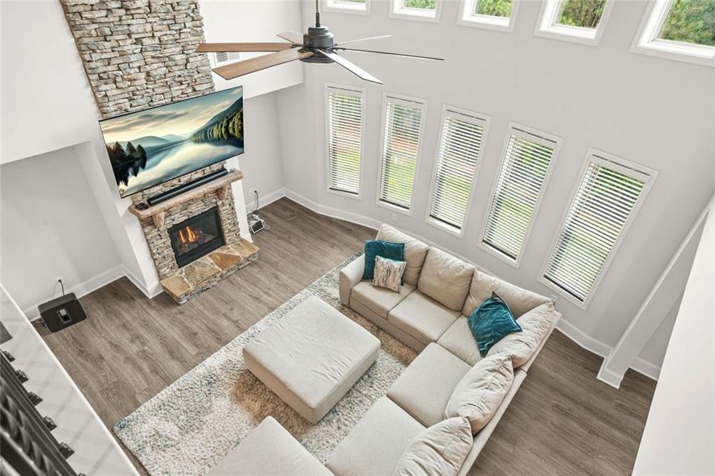 1606 Chancery Lane Lithia Springs, GA 30122 - Photo 12 of 66 a living room with furniture a fireplace and a flat screen tv