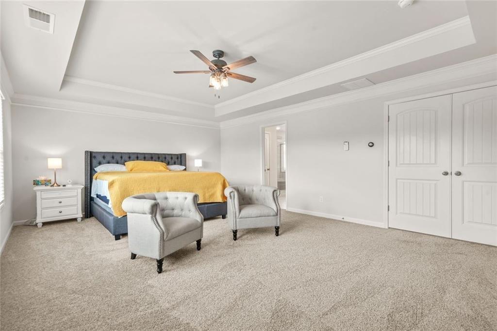 1606 Chancery Lane Lithia Springs, GA 30122 - Photo 19 of 66 a bedroom with a bed and a chandelier