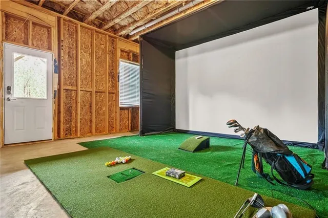 a front view of a house with a yard and potted plants