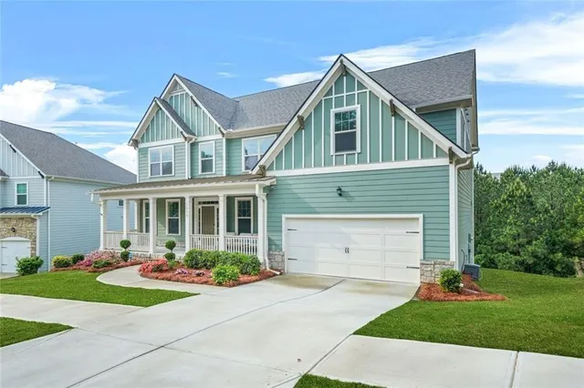 a front view of a house with a yard and garage