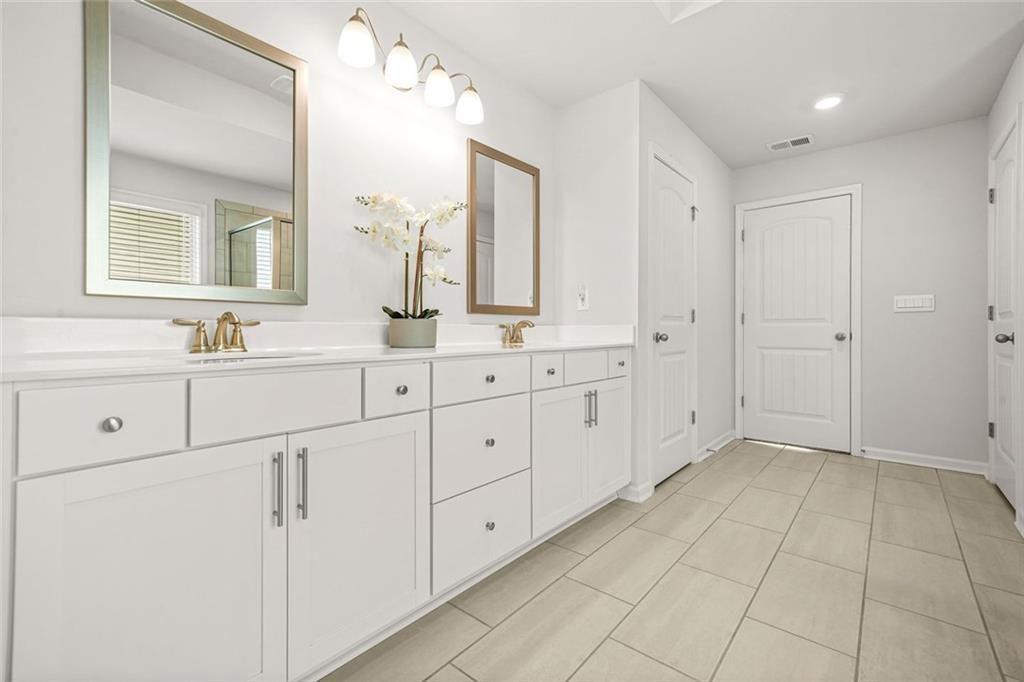 1606 Chancery Lane Lithia Springs, GA 30122 - Photo 46 of 66 a bathroom with a sink and a mirror